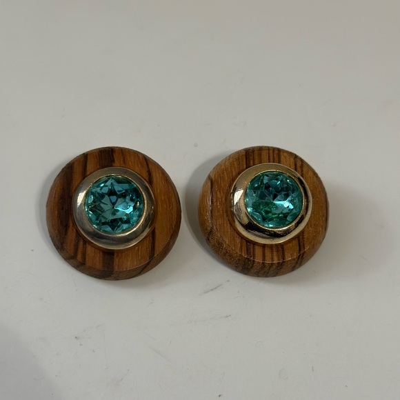 Vintage Diva Stud Earrings blue gemstone set in gold tone bezel on wooden Base